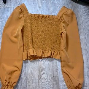 It is this cute brown top. Long sleeve and has ruffles.